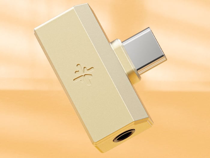 Fiio Snosky TINY dongle DAC plugged into a device with headphone attached