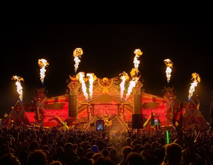 Colorful festival crowd dancing under neon lights