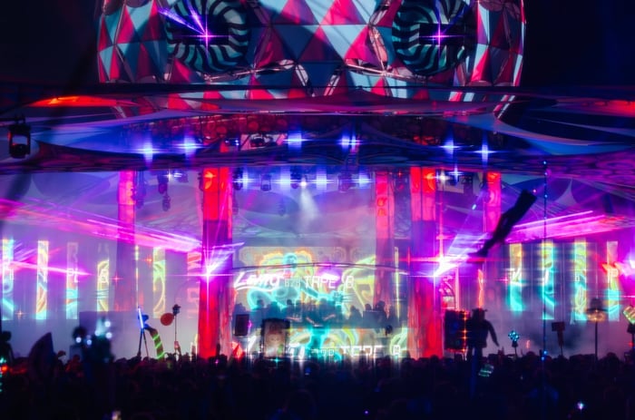 Beautifully lit stage with festival crowd