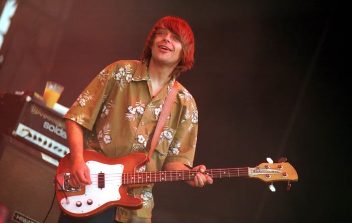 Mani performing live onstage with Primal Scream