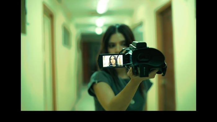 Carla captures chilling moments on camera, blurring the line between reality and the supernatural. (Credit: Ophelia)