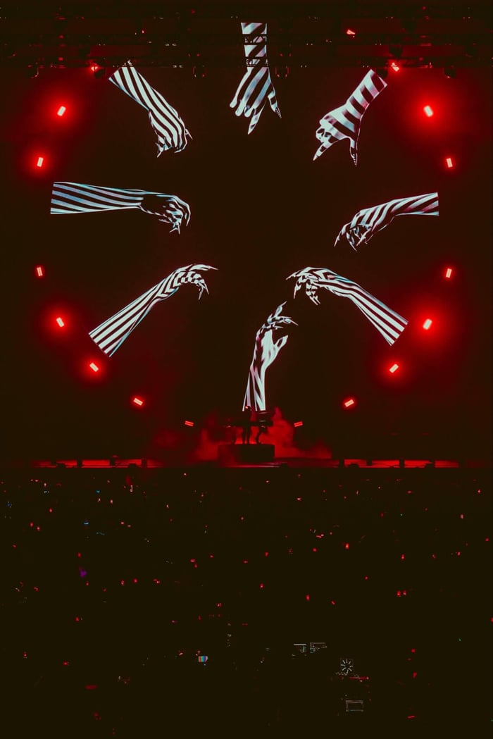 The stark lighting highlights the raw energy of her performance.