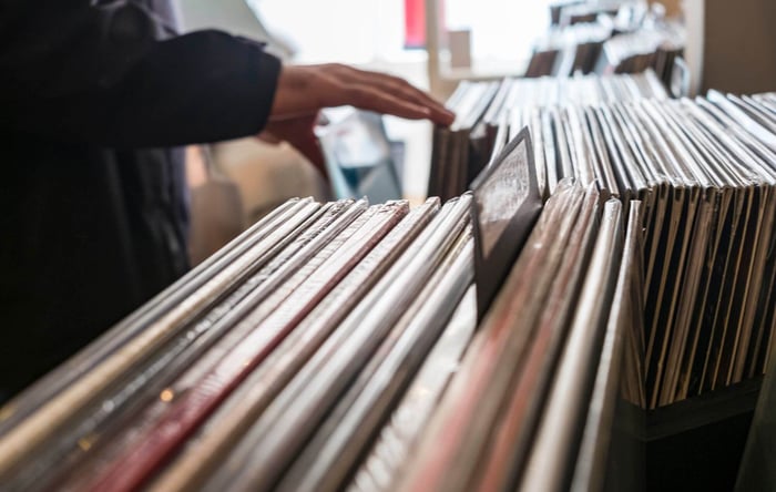 Browsing vinyl LPs in record store - stock photo