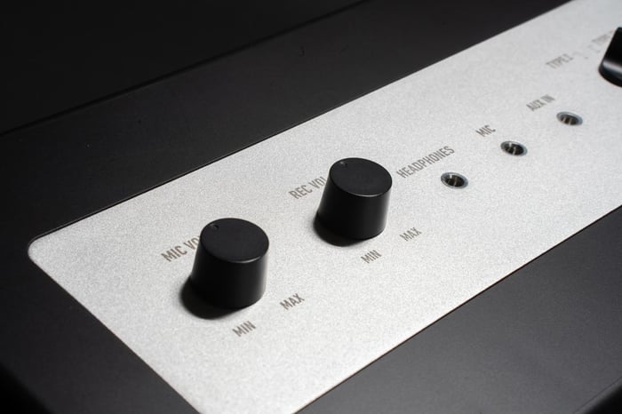 User adjusting mic volume controls