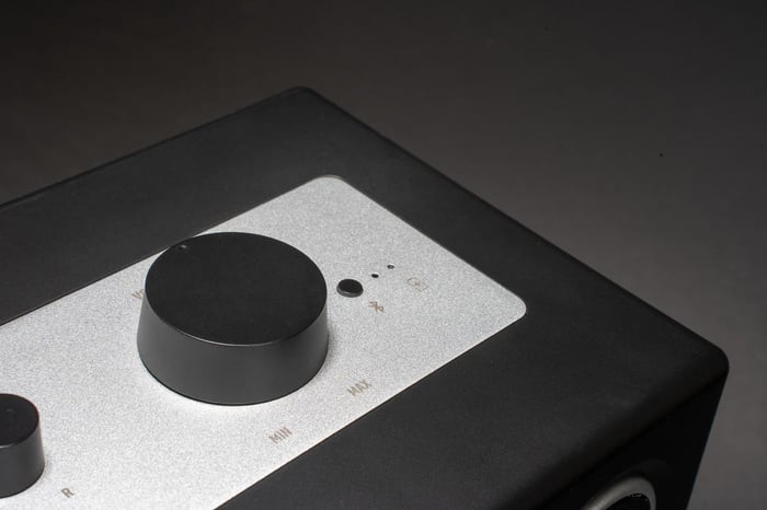 User adjusting the volume knobs