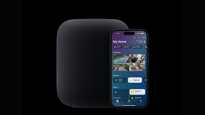 HomePod 2 speaker beside an iPhone showing Apple Home controls