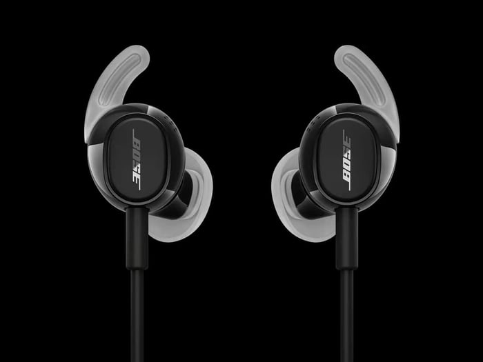 Bose earbuds shown with their cable and compact carrying accessories