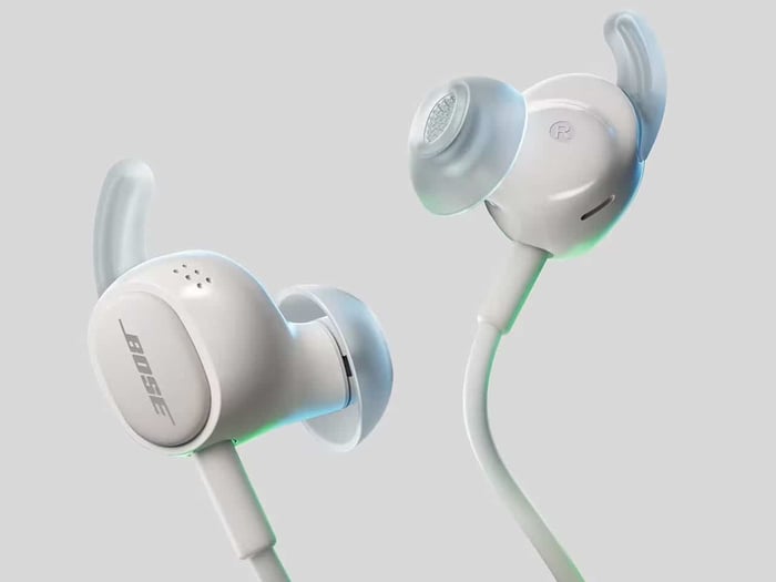 Bose earbuds shown with their cable and listening accessories