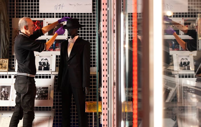 A V&A Technician adjusts the suit Bowie wore for the 1975 Grammy Awards.