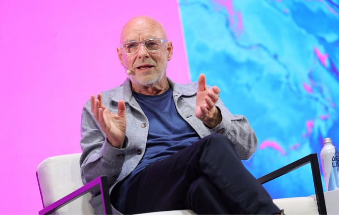Brian Eno speaks on stage in 2026