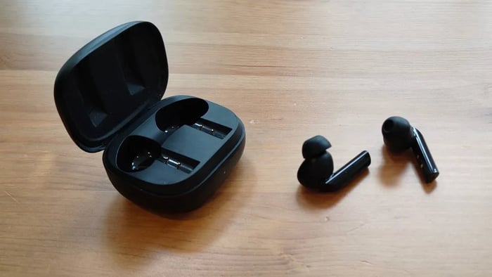 Denon AH-C840NCW earbuds and their sleek pebble-style charging case