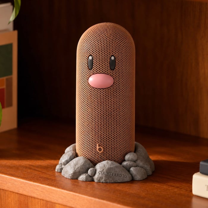 Brown Diglett speaker with raised face details and rocky base