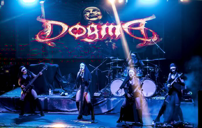 Dogma band on stage dressed as nuns