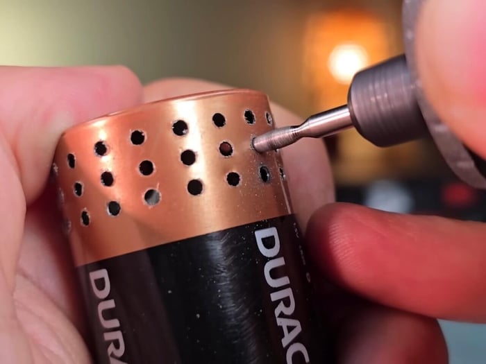 Perfectly aligned sound holes drilled into the battery shell.