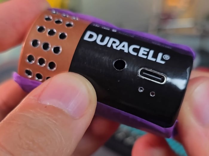 Tiny circuit board and components carefully soldered inside the battery shell.