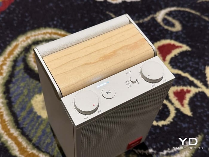 Top view showing tactile volume knobs and speaker interface