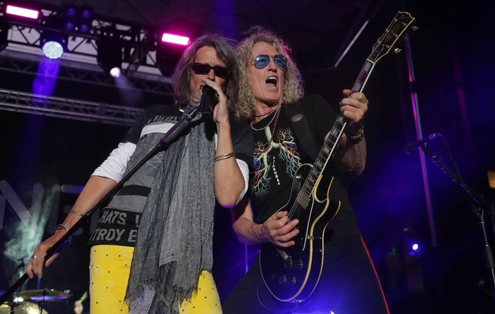 Foreigner live on stage with vibrant lighting