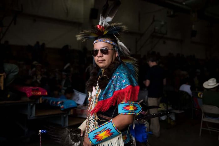 A dancer prepares at Crow Fair Pow Wow and Parade, 2018.
