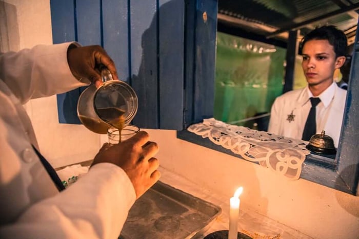 An adherent of Brazil’s Santo Daime religion waits for a dose of ayahuasca.