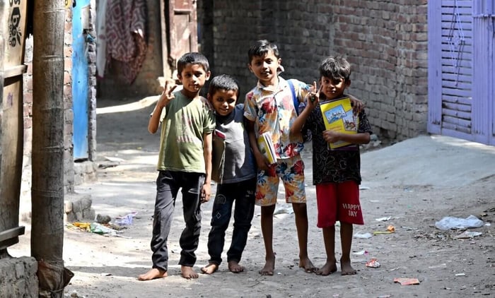 Hindu Refugee children holding books in a refugee camp in India