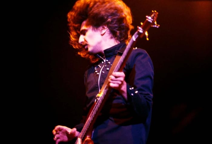Geezer Butler of Black Sabbath performs on stage at Hammersmith Odeon, London, January 1976. (Credit: Erica Echenberg/Redferns)