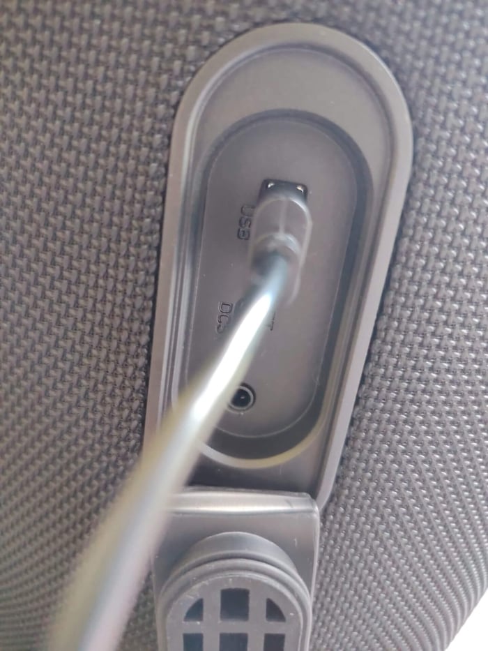 Rear panel showing input ports under a protective rubber flap.