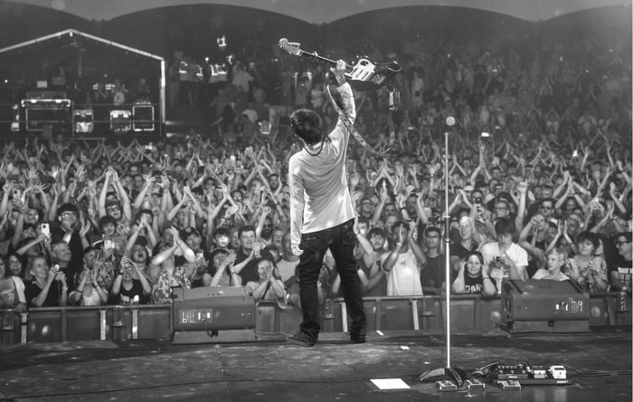 Johnny Marr performing under stage lights
