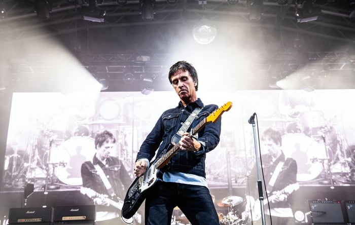 Johnny Marr playing guitar onstage in Manchester