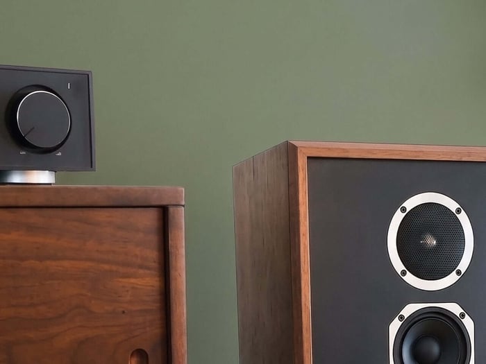 Elegantly designed with mid-century modern wood veneers and textile grilles.