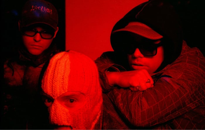 Kneecap band members striking a powerful pose.