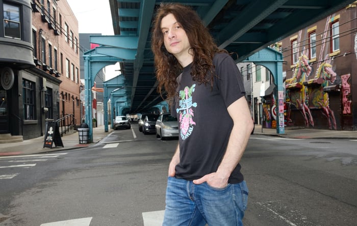 Kurt Vile seated during a relaxed backstage portrait