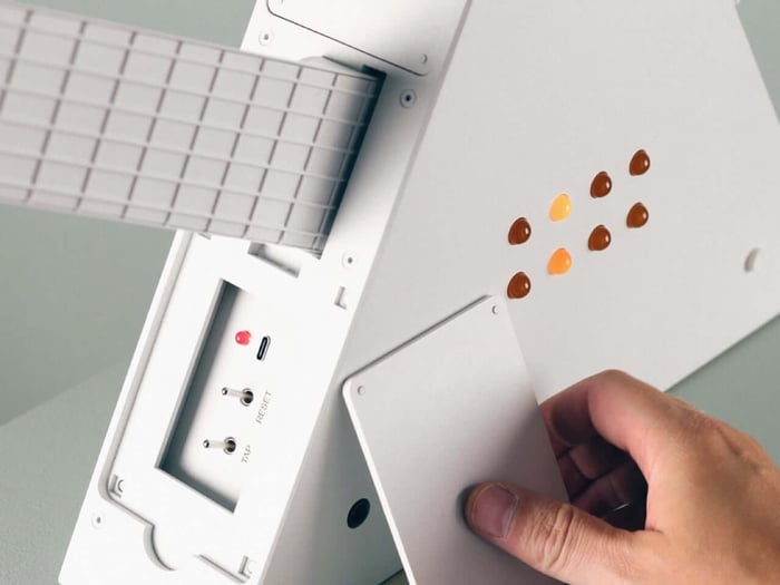 Magicos-2’s white triangular body and amber controls glow under stage lights