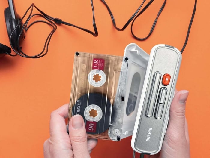 Cassette player on a wooden desk with headphones