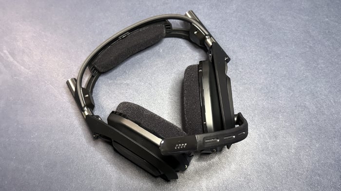 Adjustable boom microphone mutes when flipped up