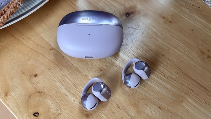 Shokz OpenDots One earbuds resting on a smooth surface