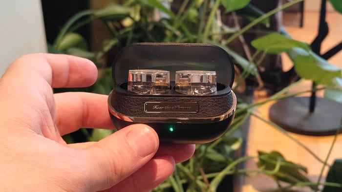 Soundpeats H3 earbuds resting inside their stylish charging case