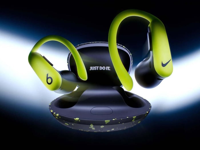 Close-up of earbuds showing Nike and Beats logos