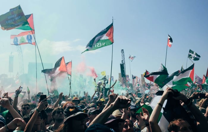 Crowds at the West Holts stage as Kneecap perform at Glastonbury 2025, photo by Andy Ford