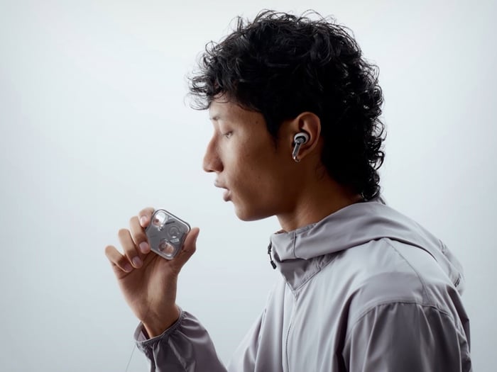 Side view of Nothing Ear (3) earbuds with charging case on a minimalist background