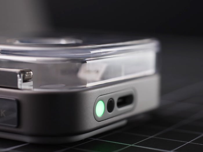 Nothing Ear (3) earbuds in white resting near their transparent charging case