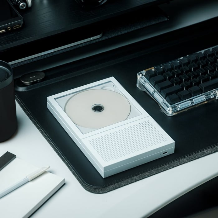 Portable CD player displaying album cover prominently