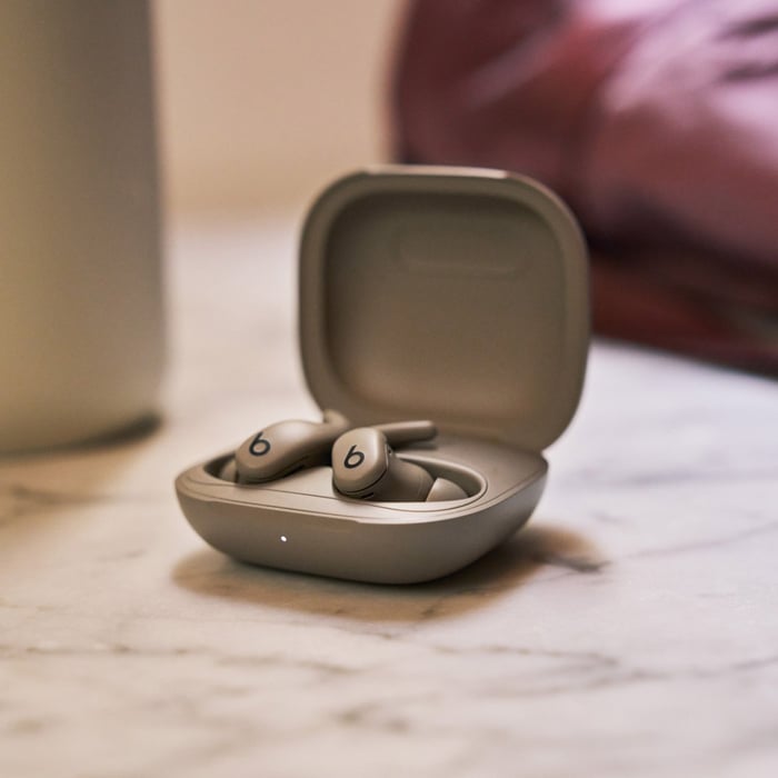 Powerbeats Fit earbuds and case with focus on controls