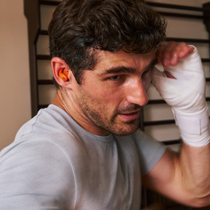Powerbeats Fit with focus on earbuds and app control