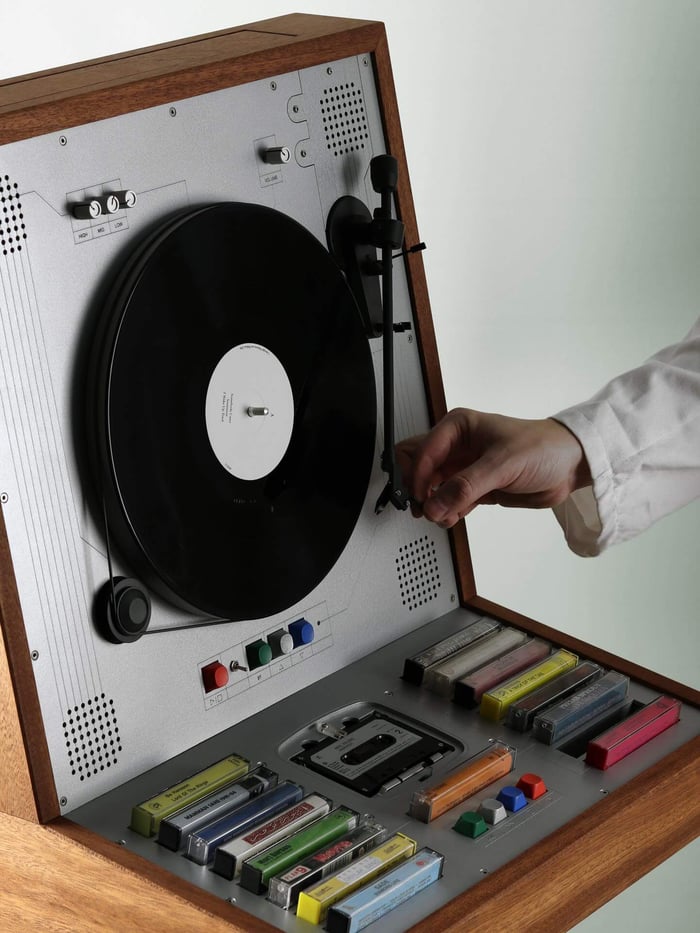 The cassette deck tucked away beneath the vertical vinyl.