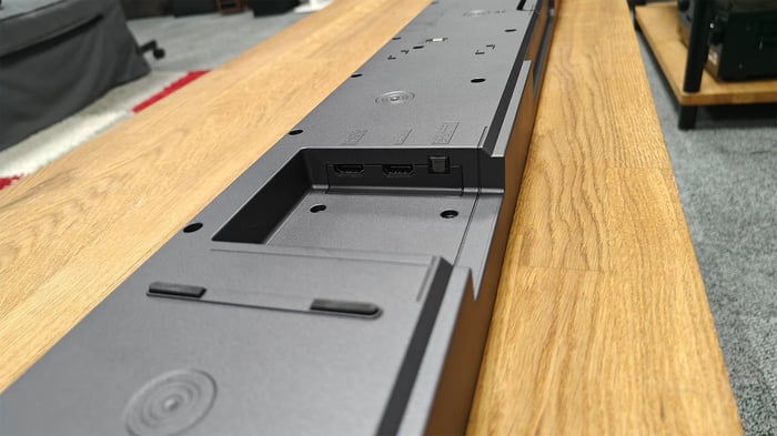 Rear panel with HDMI, optical, and other input ports