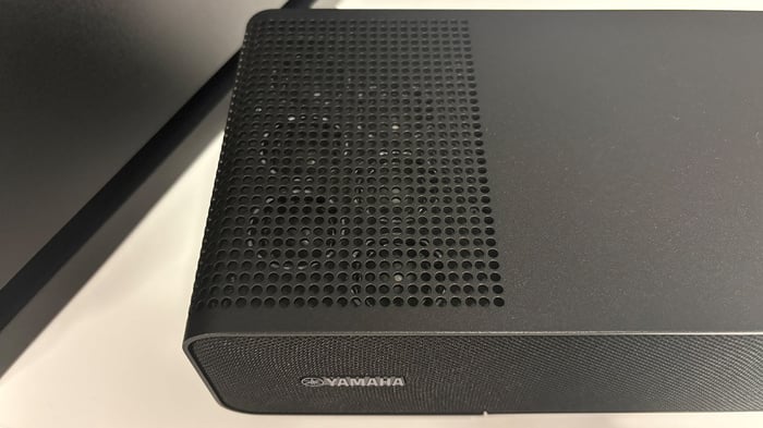 Robust and elegant Yamaha True X Surround 90A with fabric grille and metal chassis.