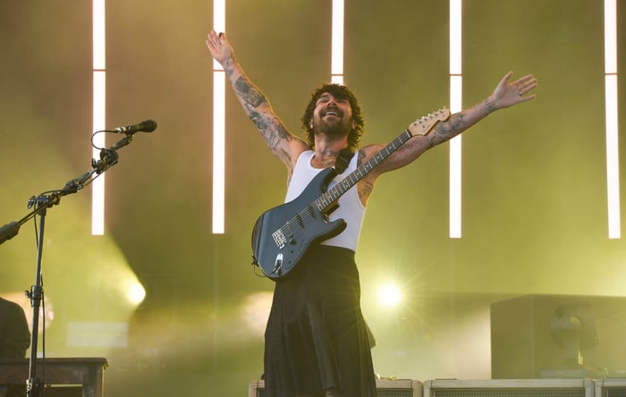 Biffy Clyro performing live, frontman Simon Neil passionately singing on stage