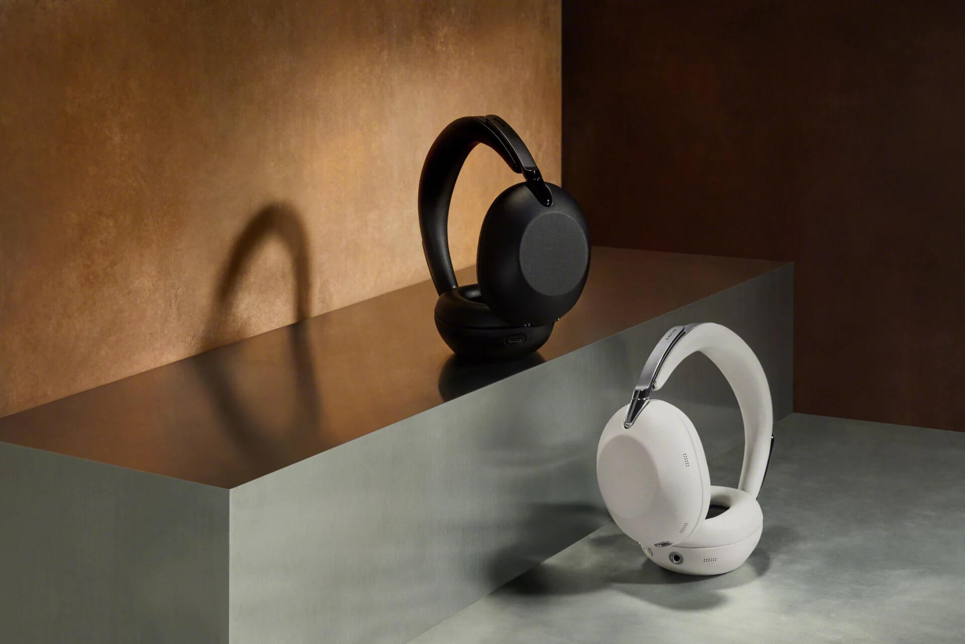 Elegant black Sony 1000X The Collexion headphones resting on a wooden surface