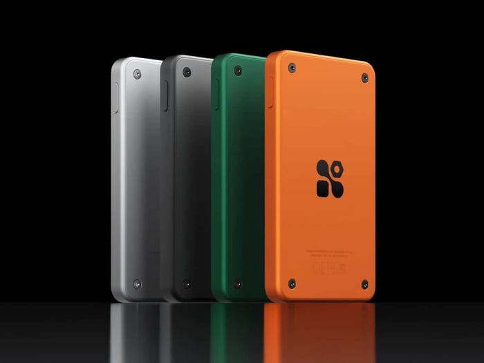 Four Sudo music players in a row showing Silver, Basalt, Forest, and Tangerine colorways from the back