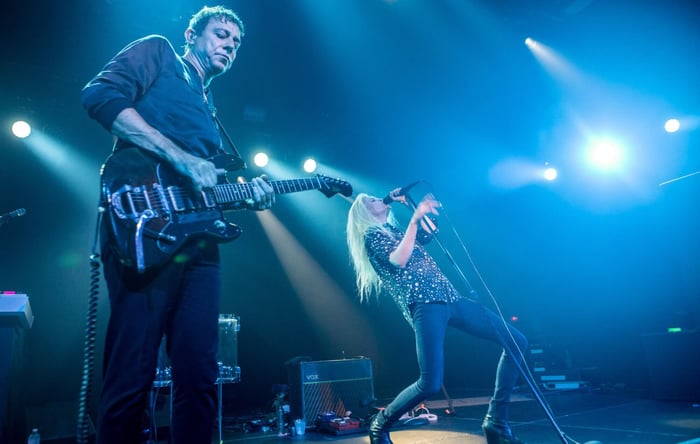 Jamie Hince of The Kills performing live, a testament to his raw musical energy.